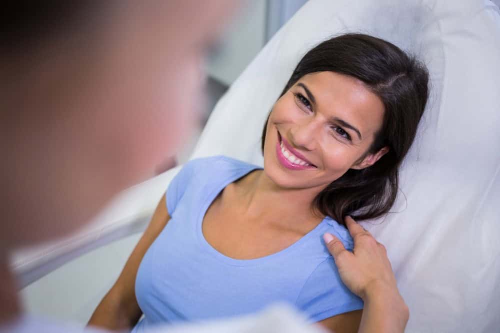 Woman smiling after pelvic floor prolapse surgery consultation.